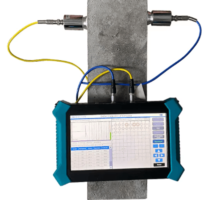 Ultrasonic test instrument connected to two transducers on a test sample
