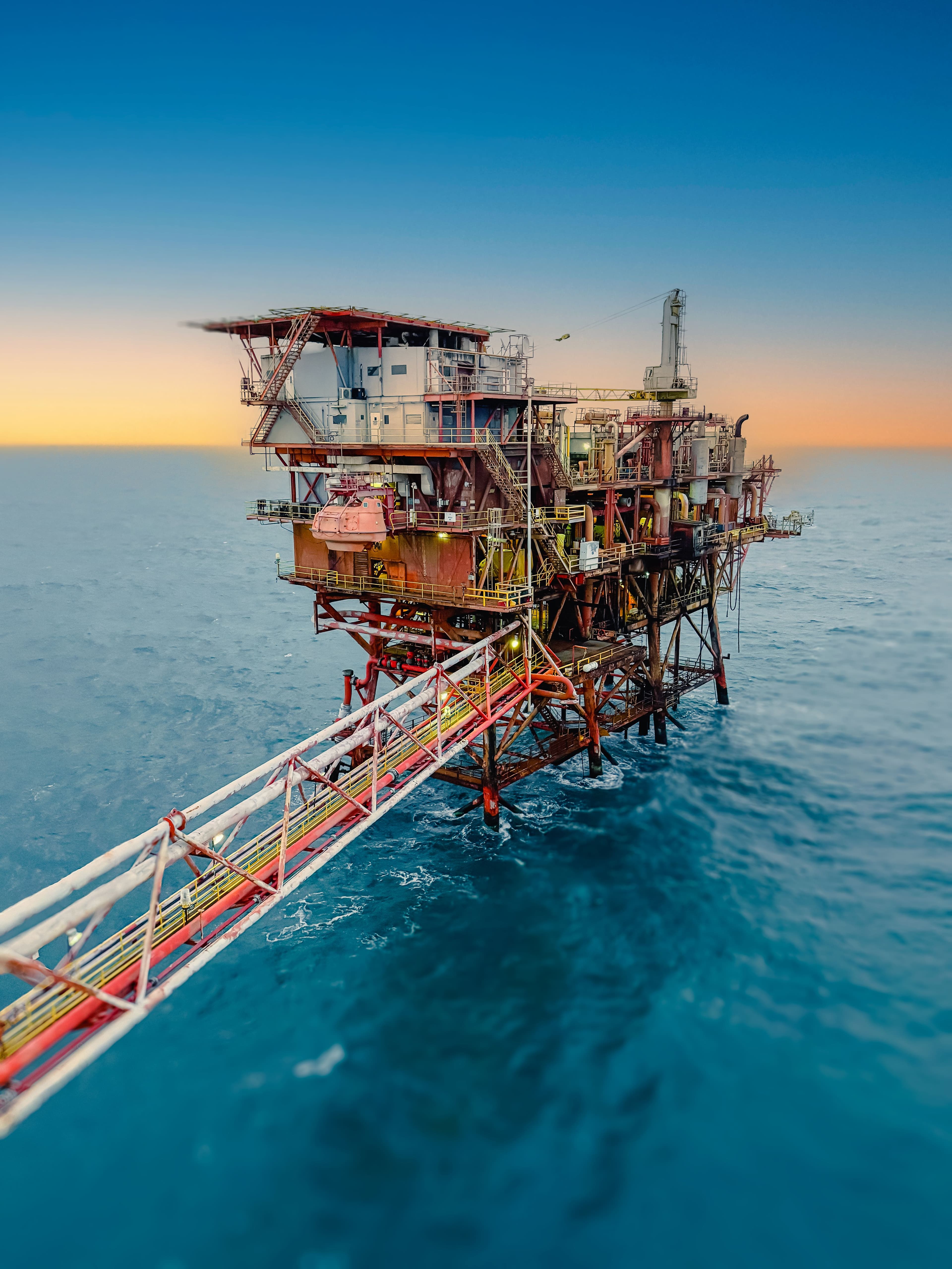 An offshore production platform at sea at dusk